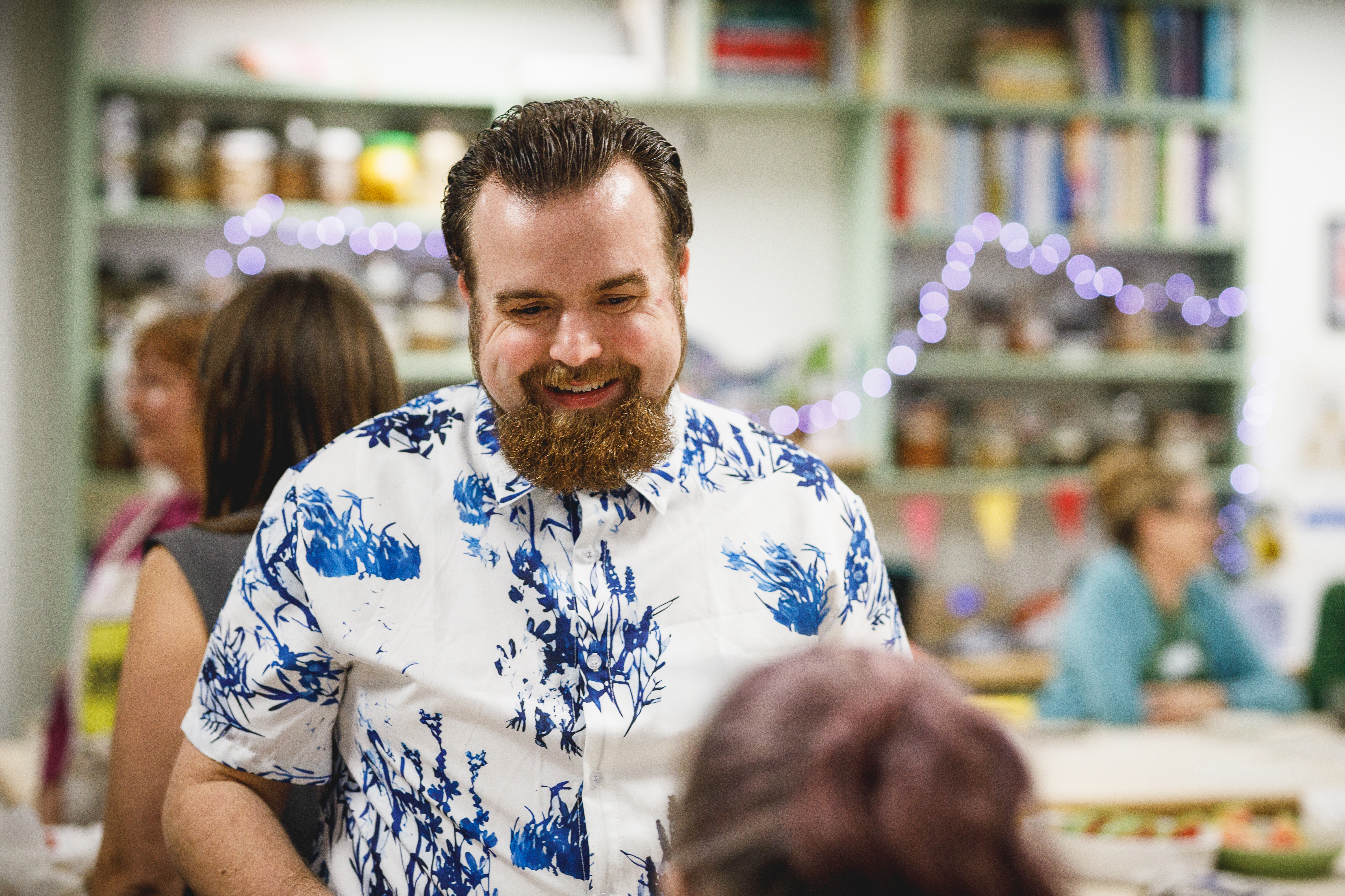 Man in blue and white shirt at a party smiling.jpg