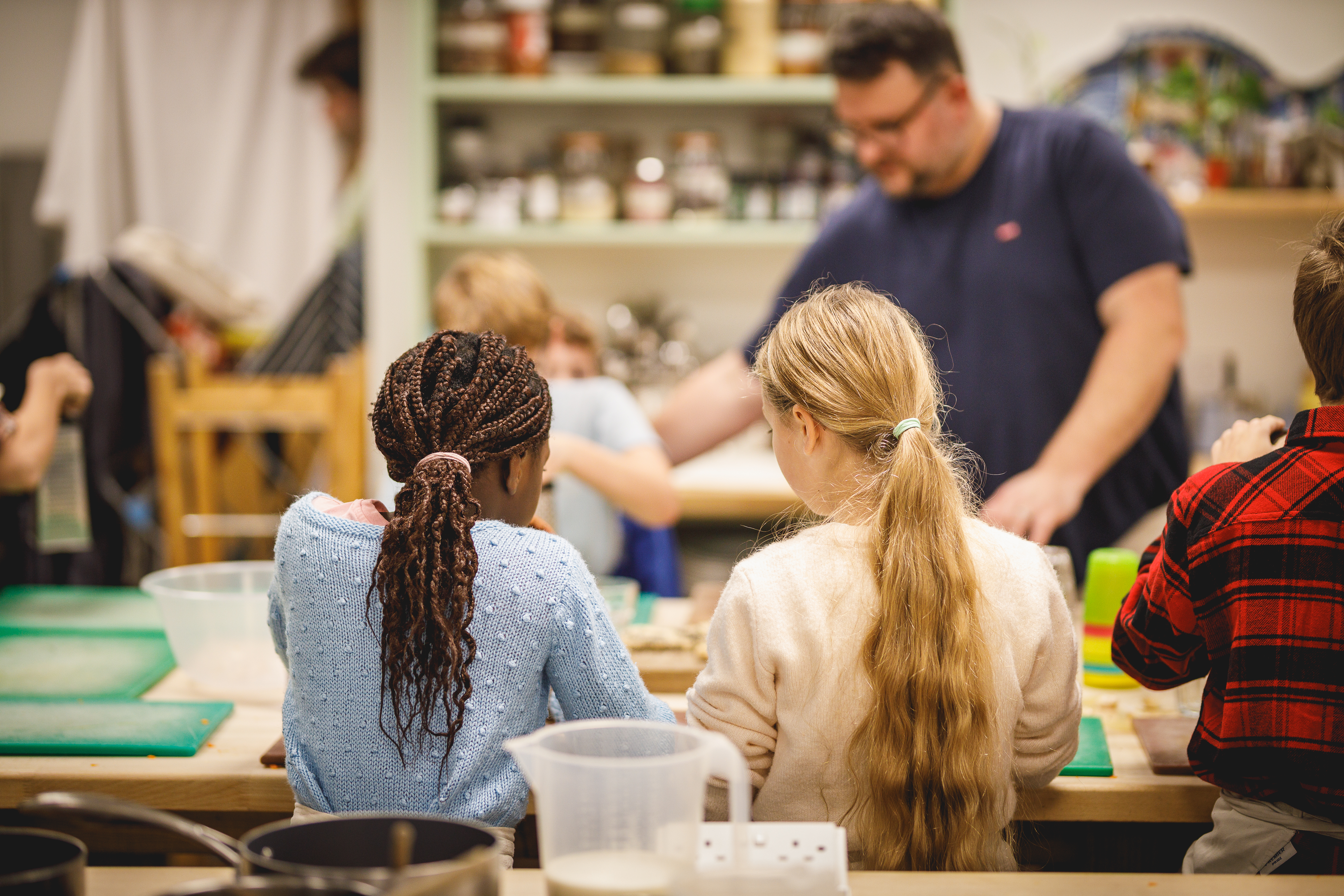 Two girls chopping vegetables together.jpg