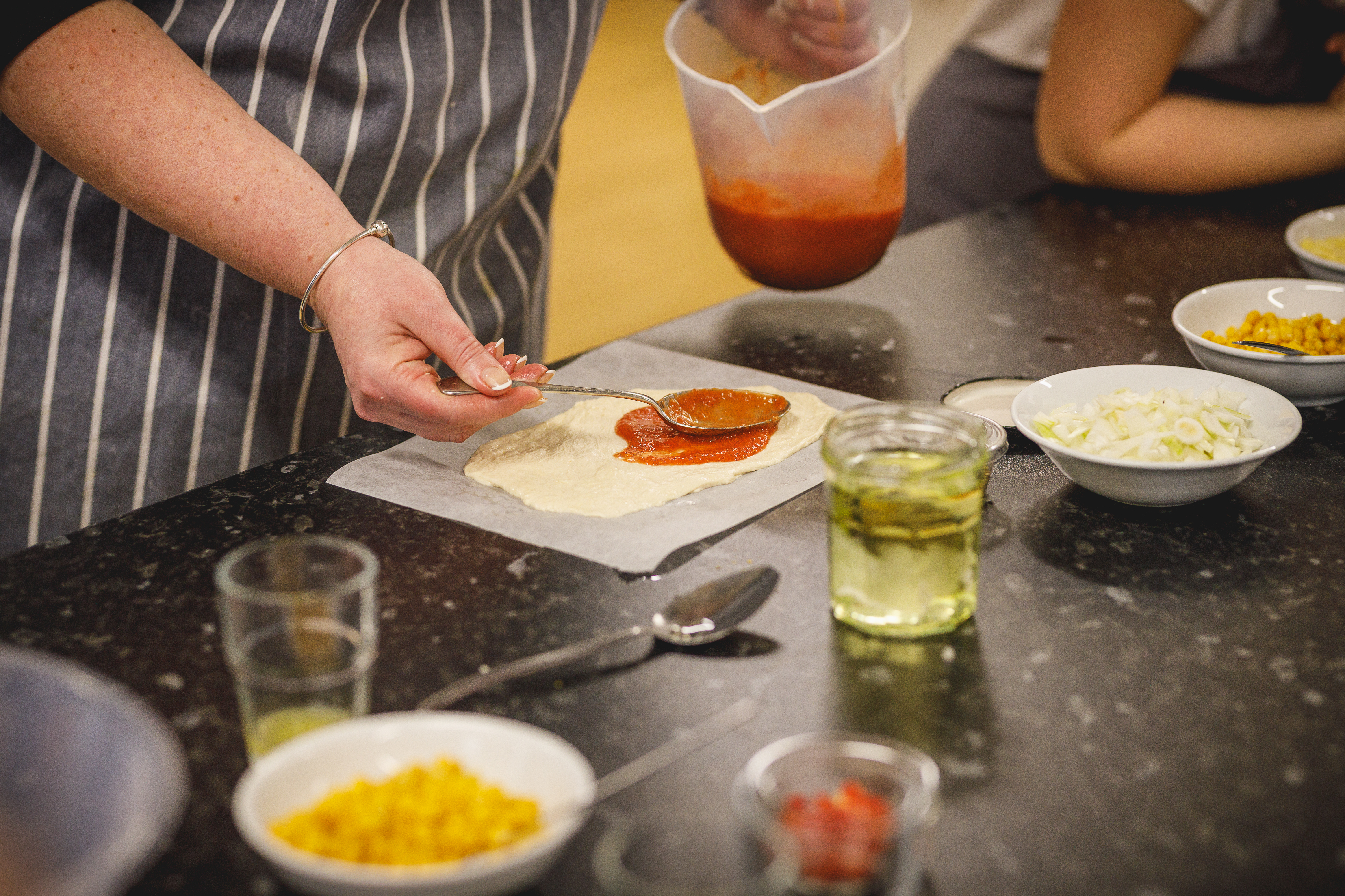 Close up of someone's hands making a pizza.jpg