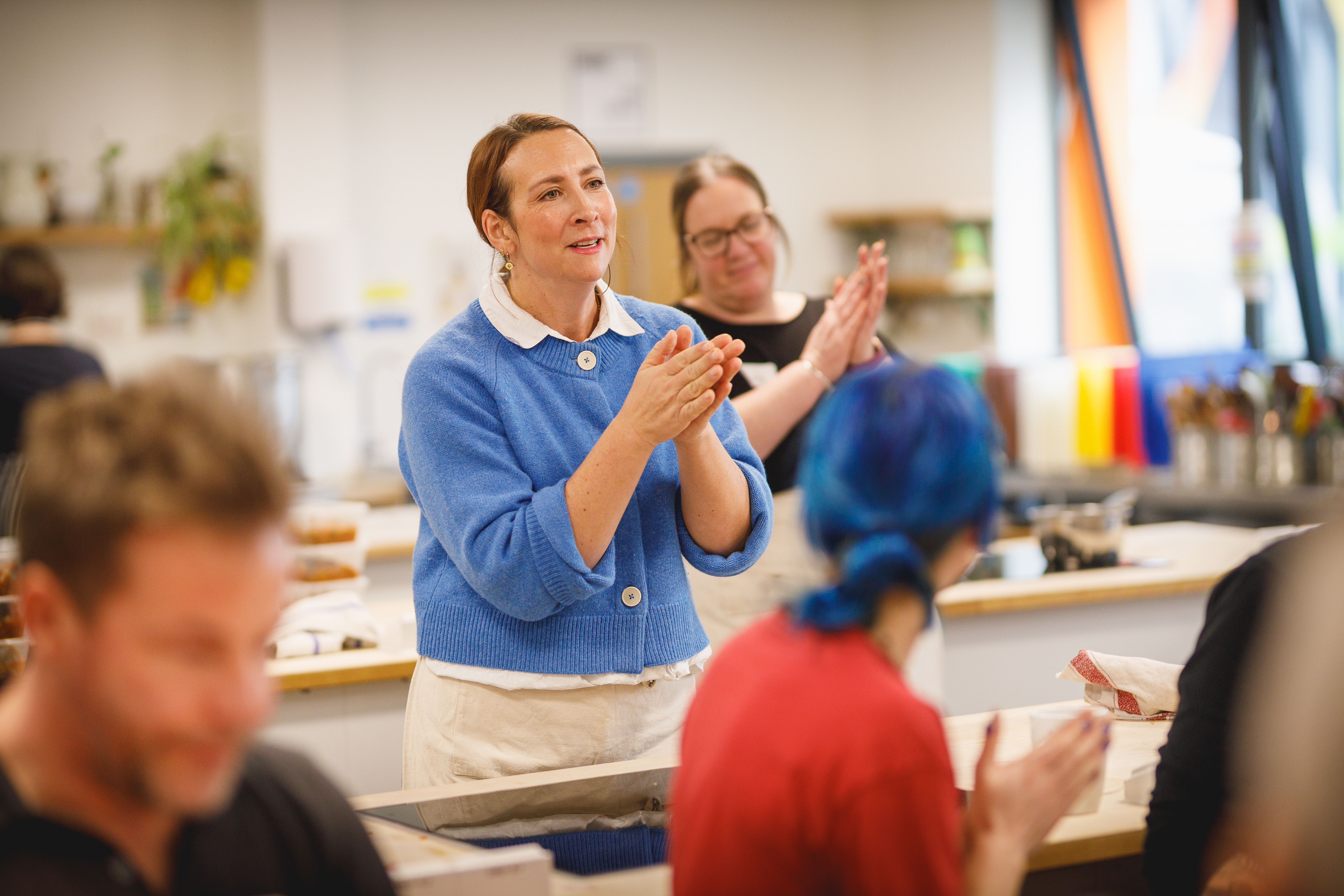 Teacher Charlotte clapping at the end of a class.jpg