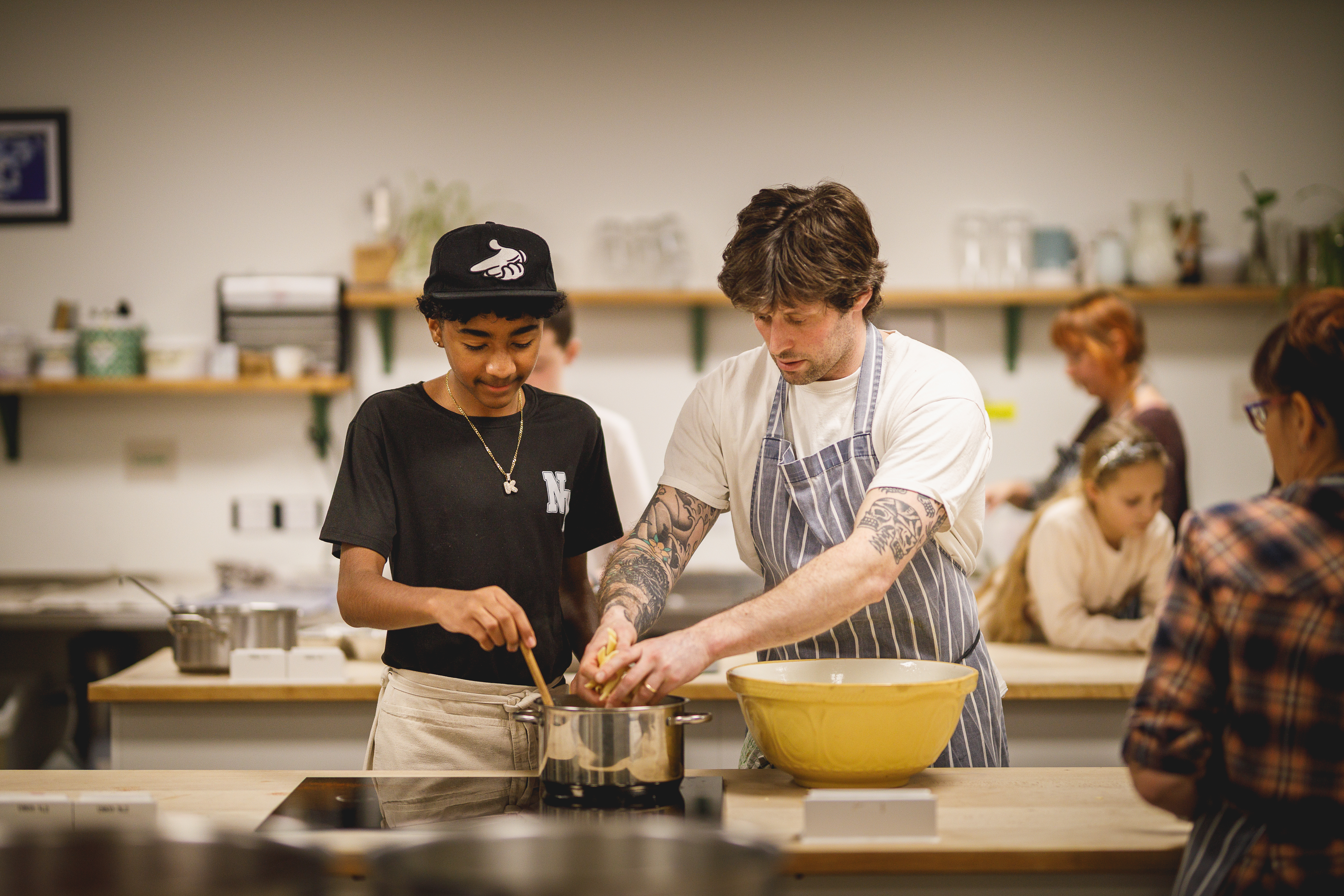 Chef teaching young person in cookery school.jpg