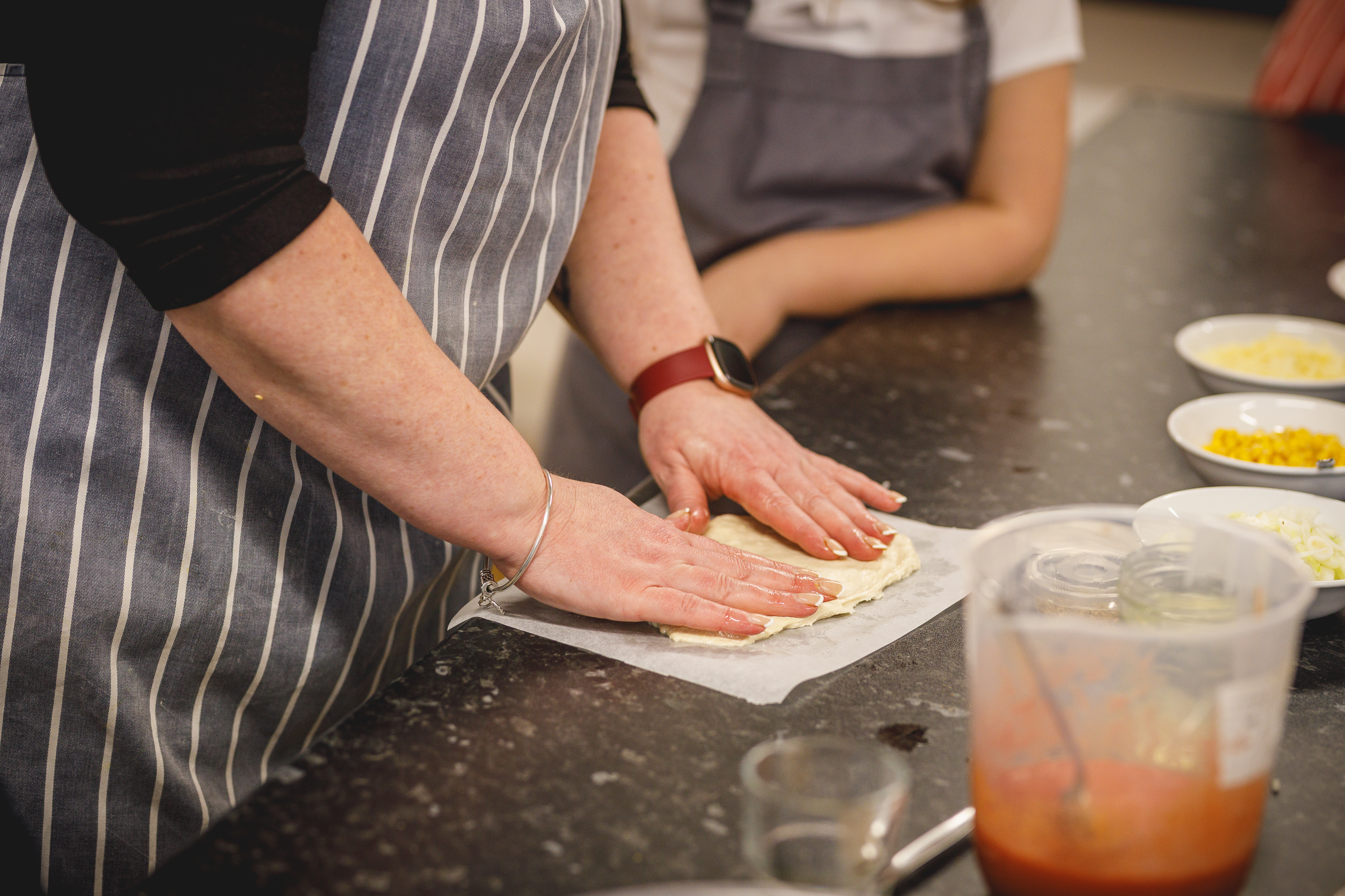 Close up of hands making dough on a kitchen worktop.jpg