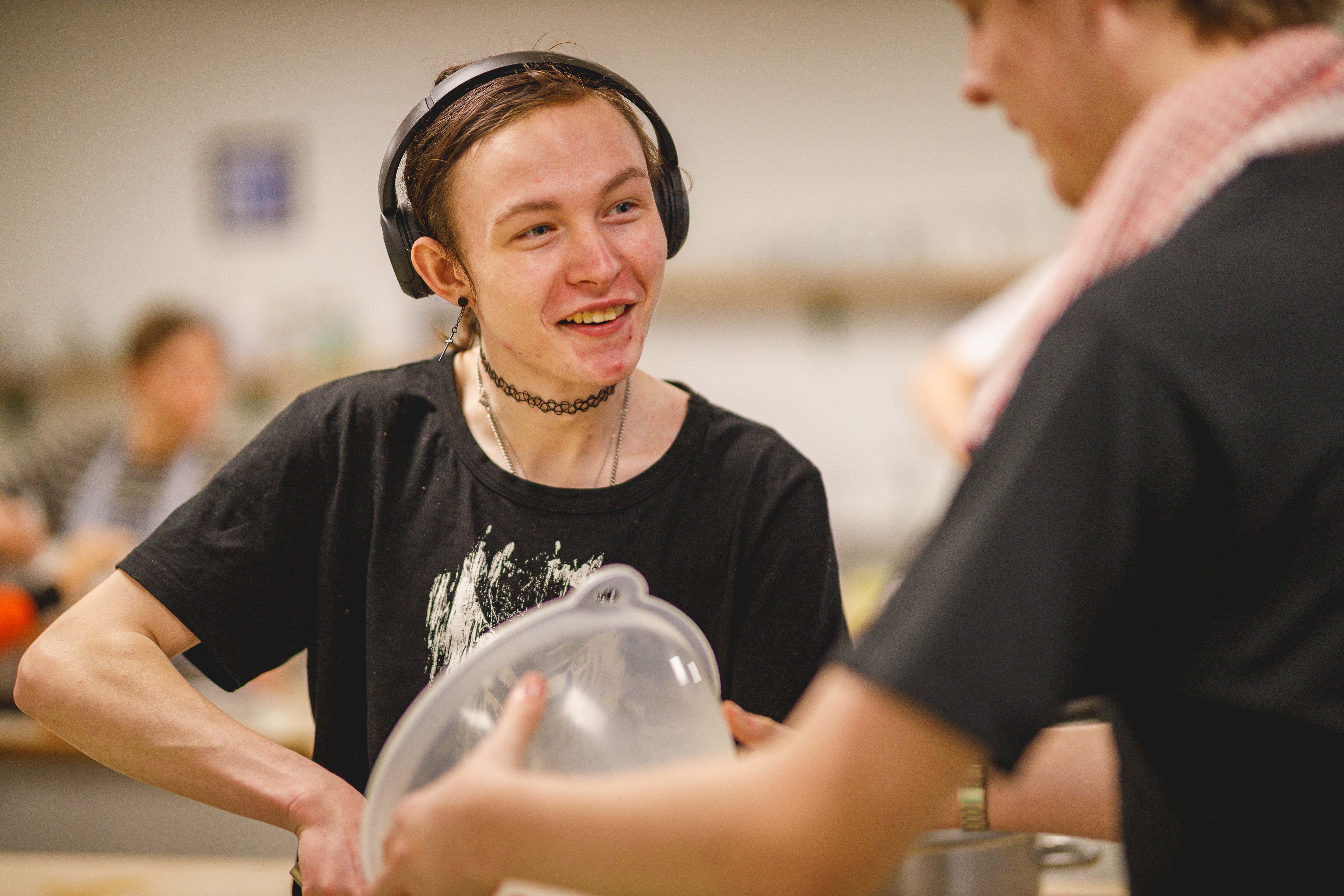 How to be a chef student with headphones on smiling in the kitchen.jpg