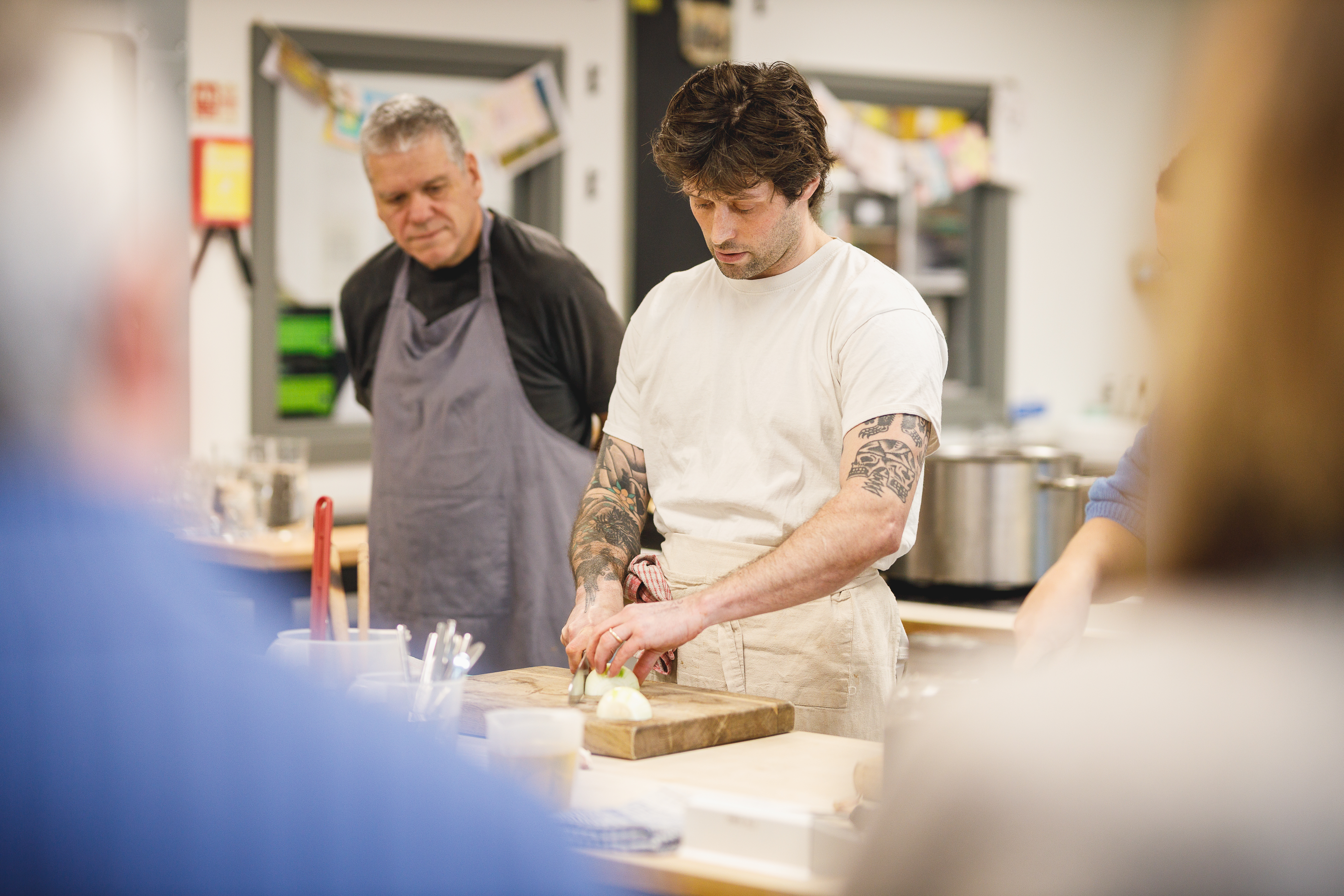 Cookery teacher Jesse showing how to chop an onion.jpg