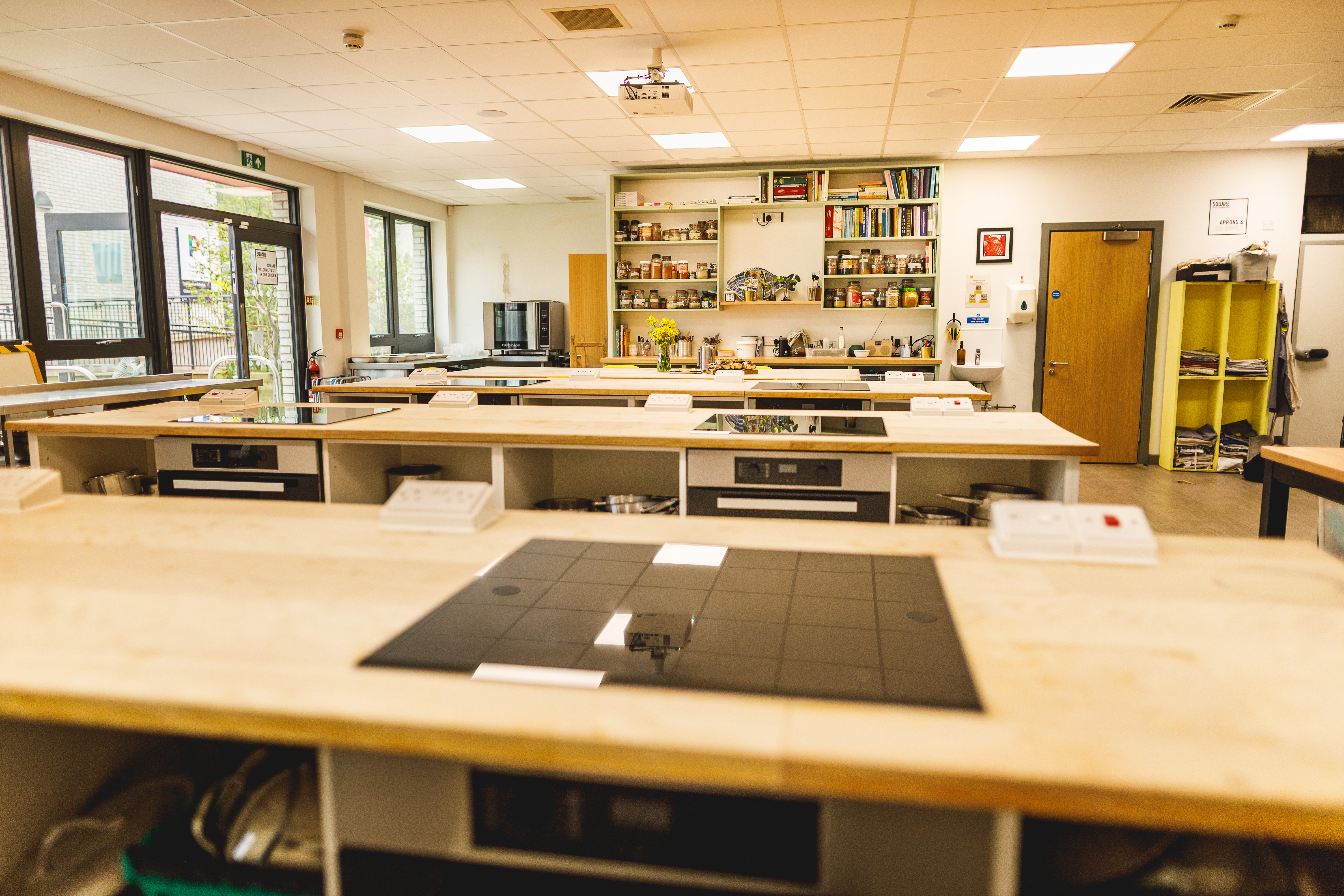Wide shot of cookery school showing hobs, ovens and worktops.jpg