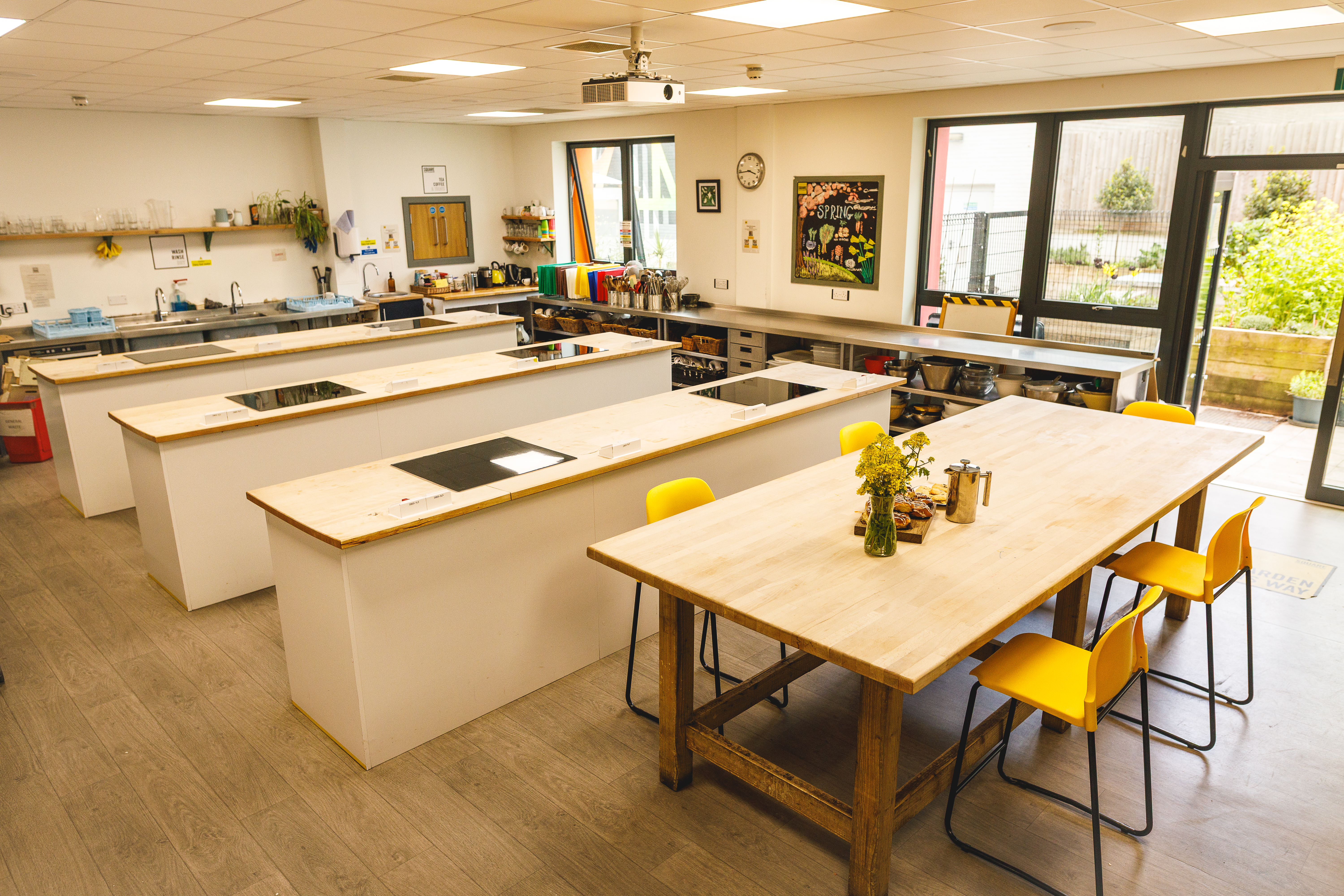 Square Food Foundation kitchen with table and work stations.jpg